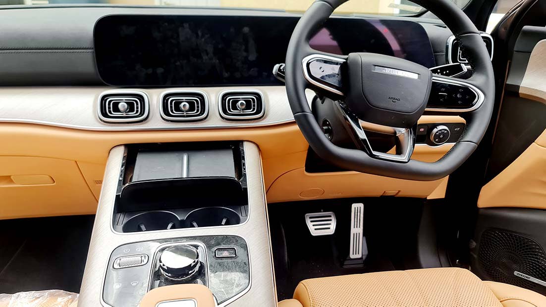 The centre console is anchored by a stunning transparent gear selector that catches the light, surrounded by a minimalist layout that ditches clutter for class.