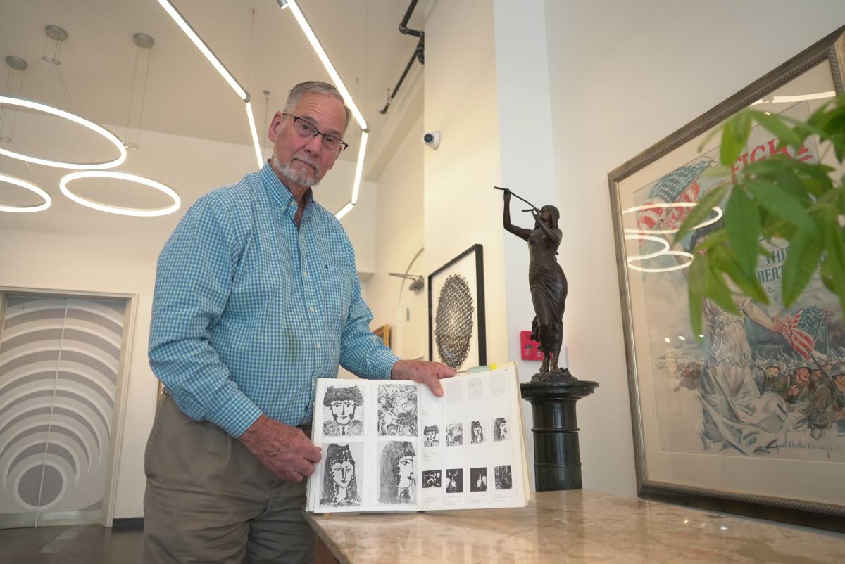 Art dealer Bill DeLind shows a picture of a Pablo Picasso sketch (upper left) stolen from his shop DeLind Fine Art Appraisals in 2018 in Milwaukee on Aug. 14, 2026. The sketch was recently found in town. 