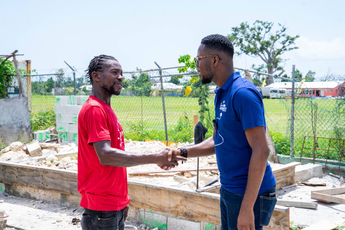 Richard Ruddock (left), a father of six from Llandilo, Westmoreland, thanks Omar Wright, lead, Environment & Community Development Programmes at the JN Foundation, for the grant.