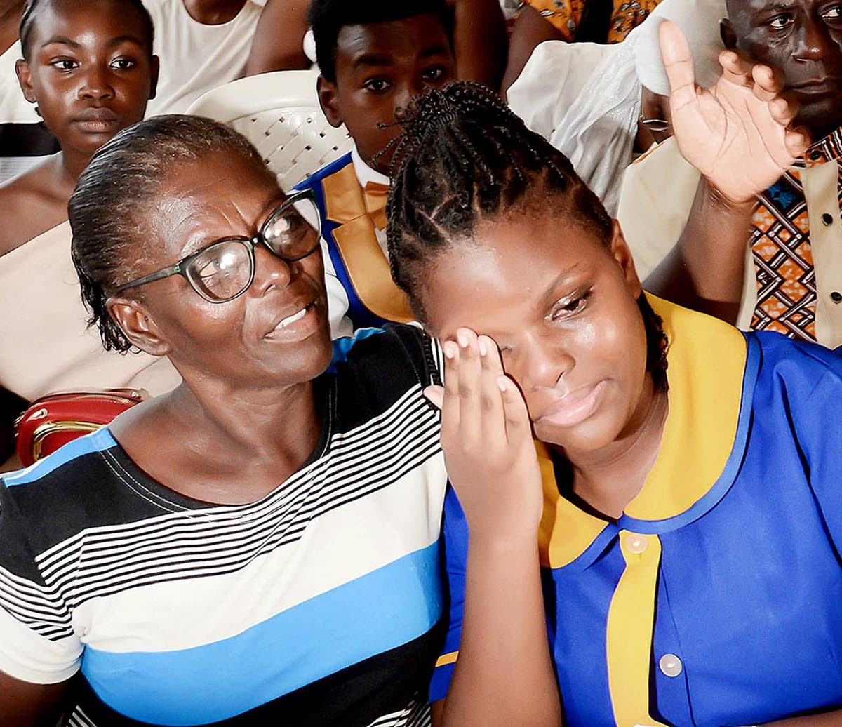 Nisia Tracey, of Runaway Bay Primary School, is overcome with emotion and comforted by her grandmother after learning that she was named top girl performer in the Discovery Bauxite zone of the Primary Exit Profile (PEP) examinations. 