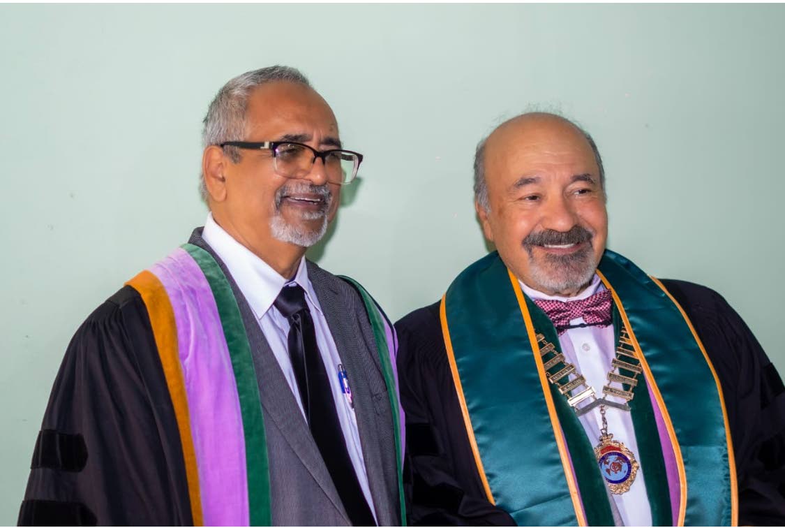 Dr Delroy Fray (left) sharing a light moment with Dr.Julio Rodrigues, the global president of the International College of Dentists (ICD), after receiving his ICD fellowship citation.