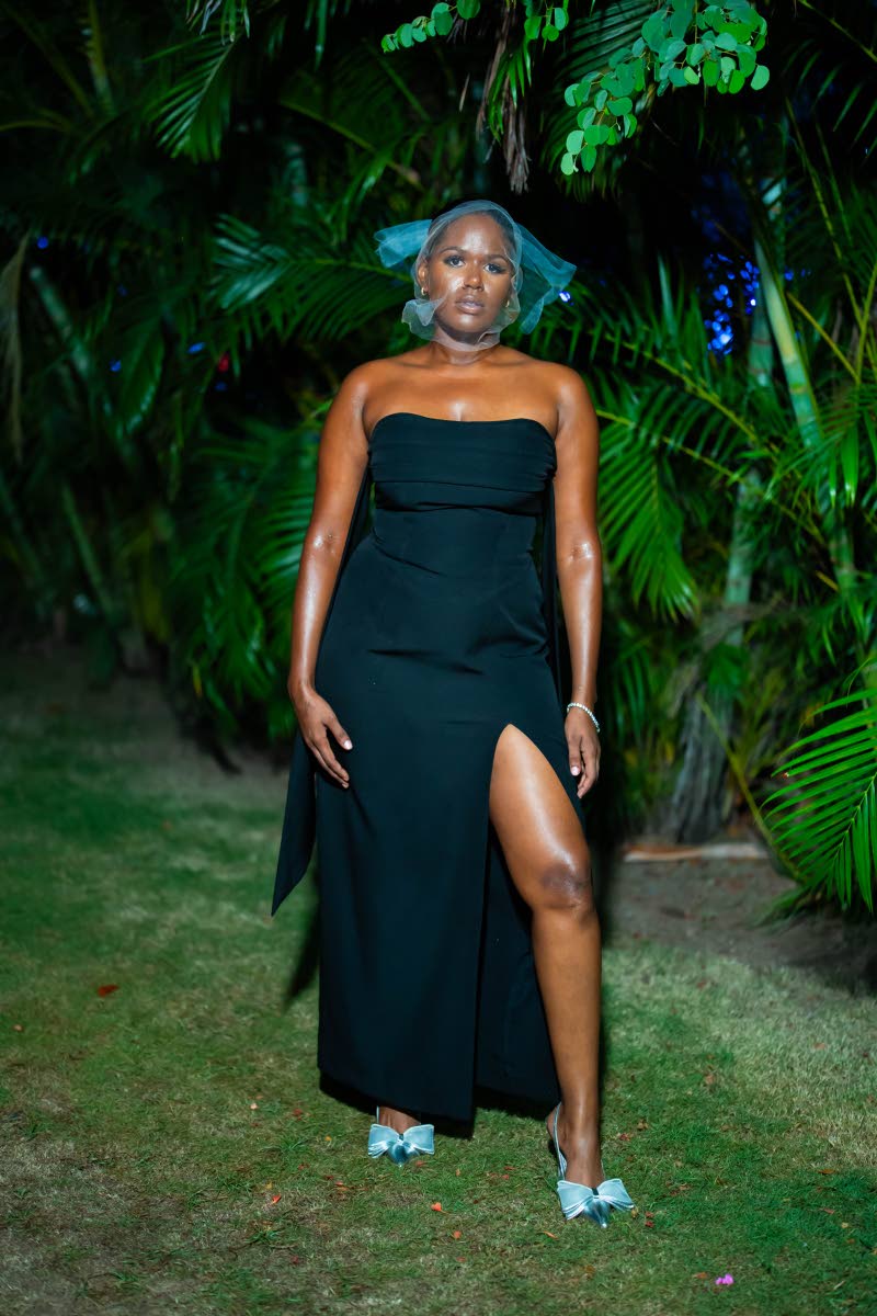 Chevon Vassell makes a strong case for the black dress in a strapless floor-length number with a thigh-high slit.