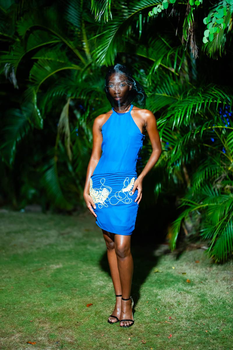 Leonie Campbell wears a blue halter dress with hand-applied details. 