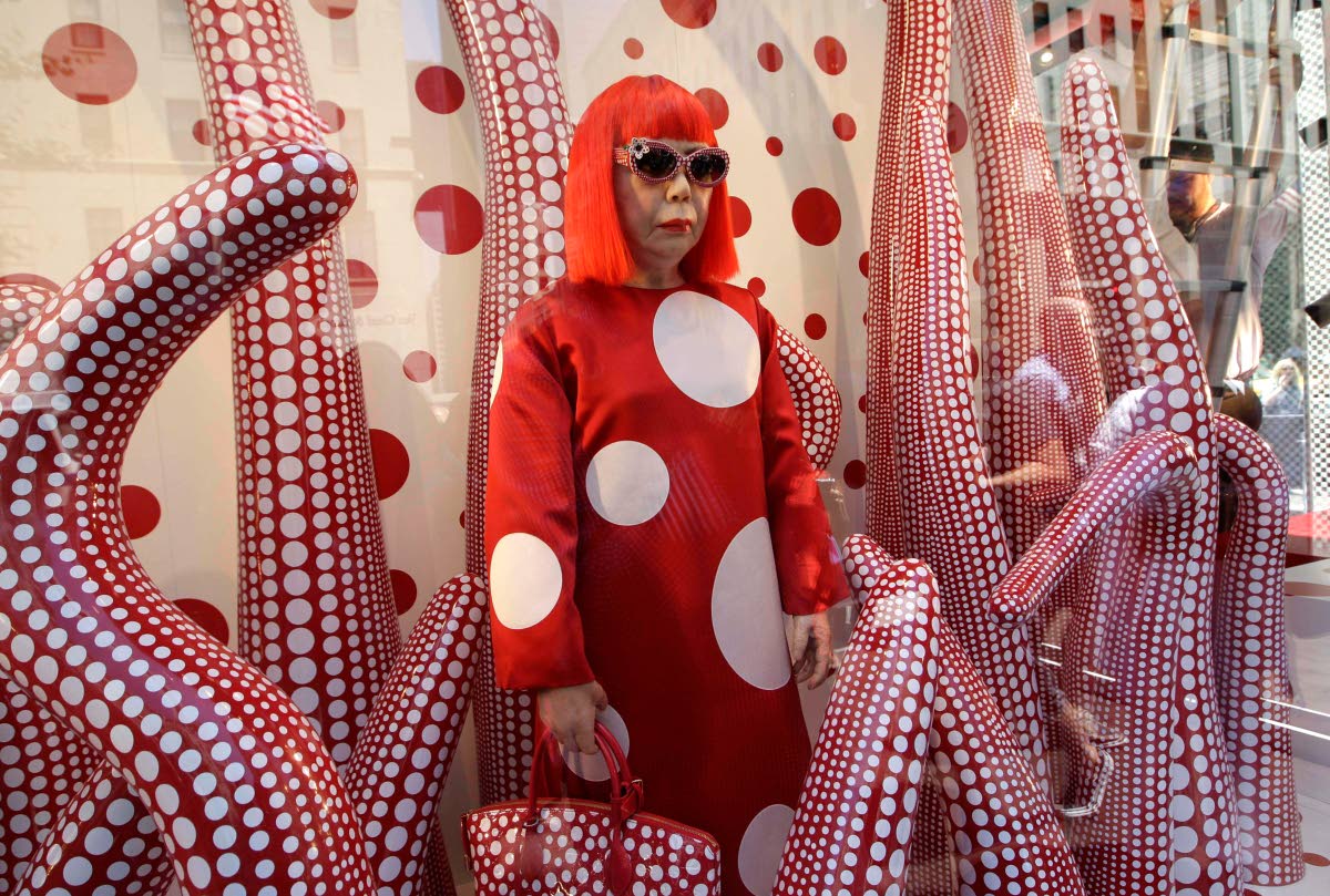 A wax model of Japanese artist Yayoi Kusama is displayed in the windows of Louis Vuitton’s flagship Fifth Avenue store in New York, in this July 10, 2012, file photograph. 