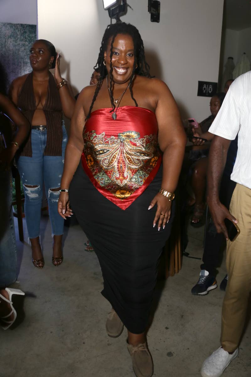 Vocalist Courtni dons a red-and-gold ornate scarf-print strapless top.