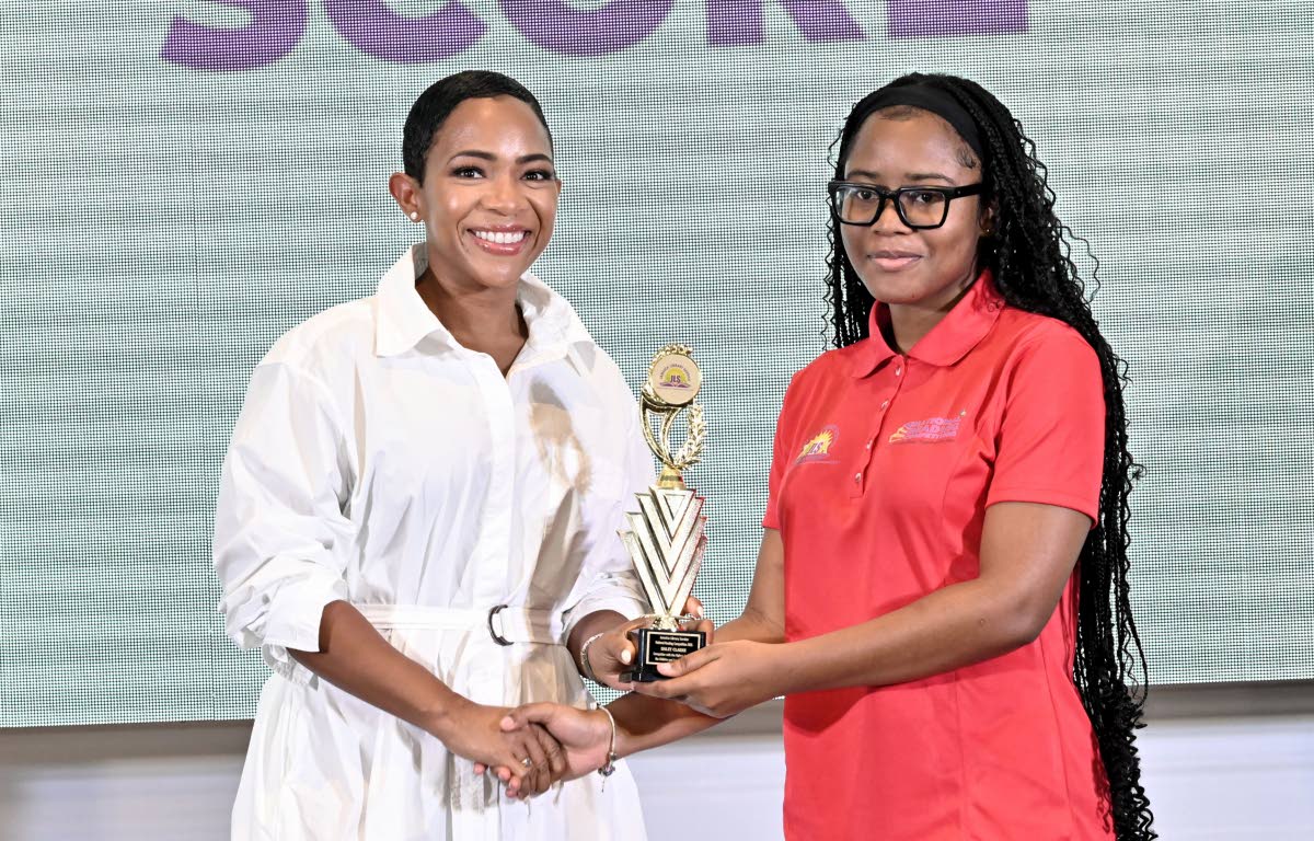 Nicole McLaren Campbell (left), chairman of the Jamaica Library Service (JLS), presents the JLS highest overall score award to Haley Clarke, of the 15-20 age group.