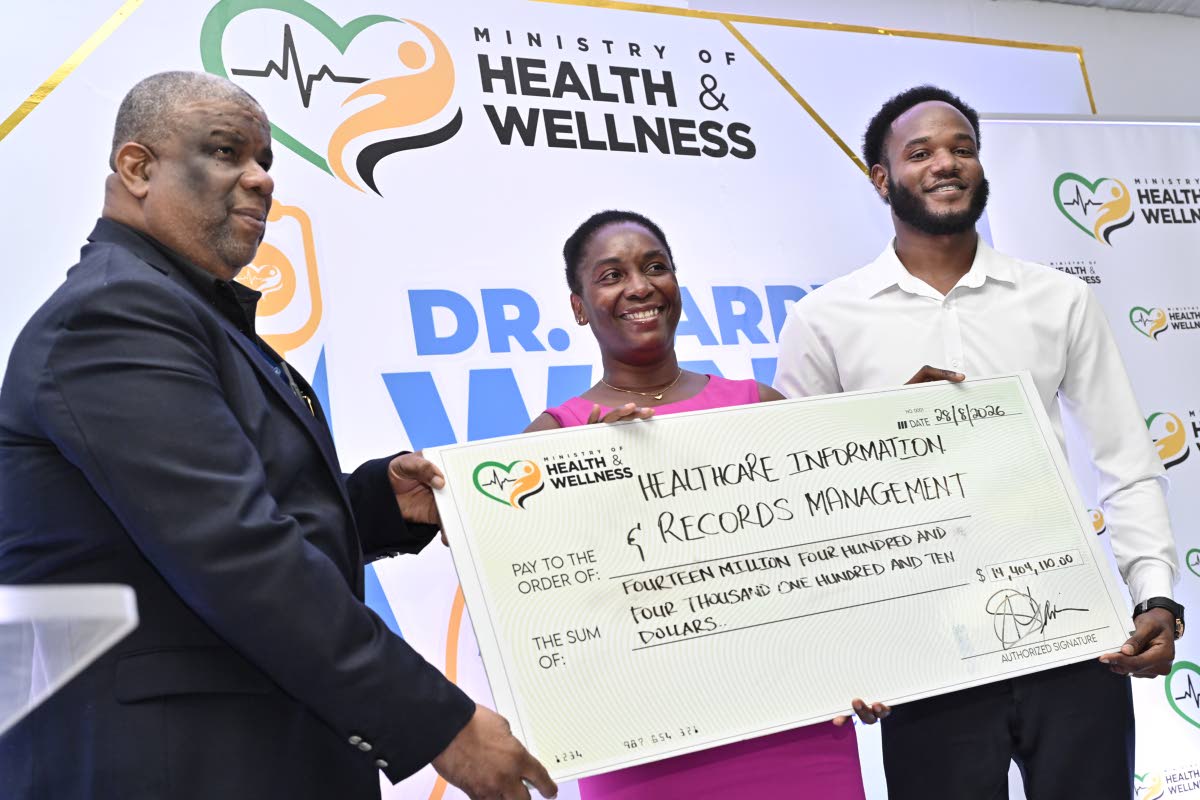 Errol Greene (left), permanent secretary in the Ministry of Health and Wellness, presents a  scholarship cheque to Amoya Passley and Andre Ranger, for oral health studies.