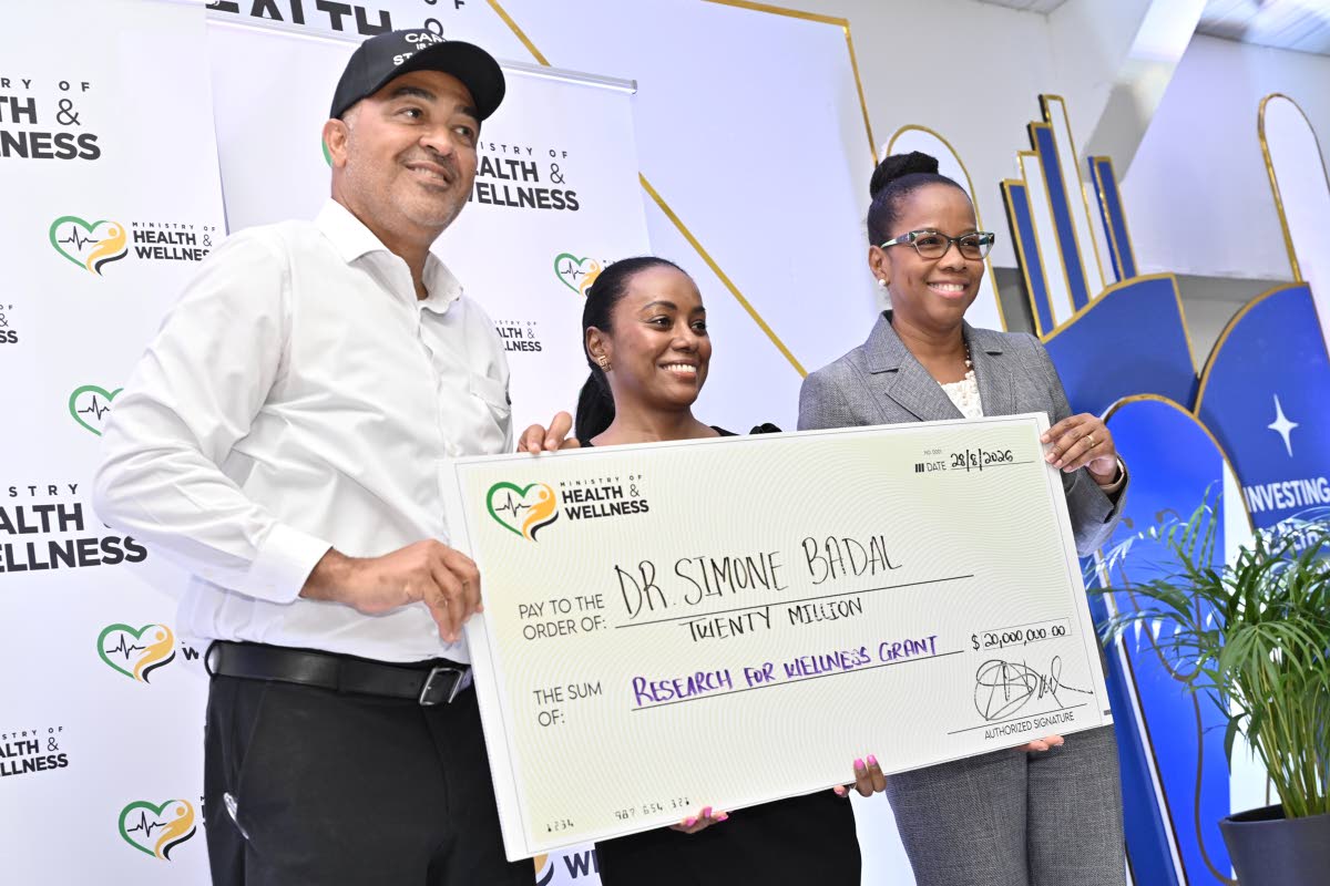 Dr Christopher Tufton, minister of health and wellness; and Dr Karen Webster Kerr (right), national epidemiologist in the Ministry of Health and Wellness, present a grant to Dr Simone Badal.