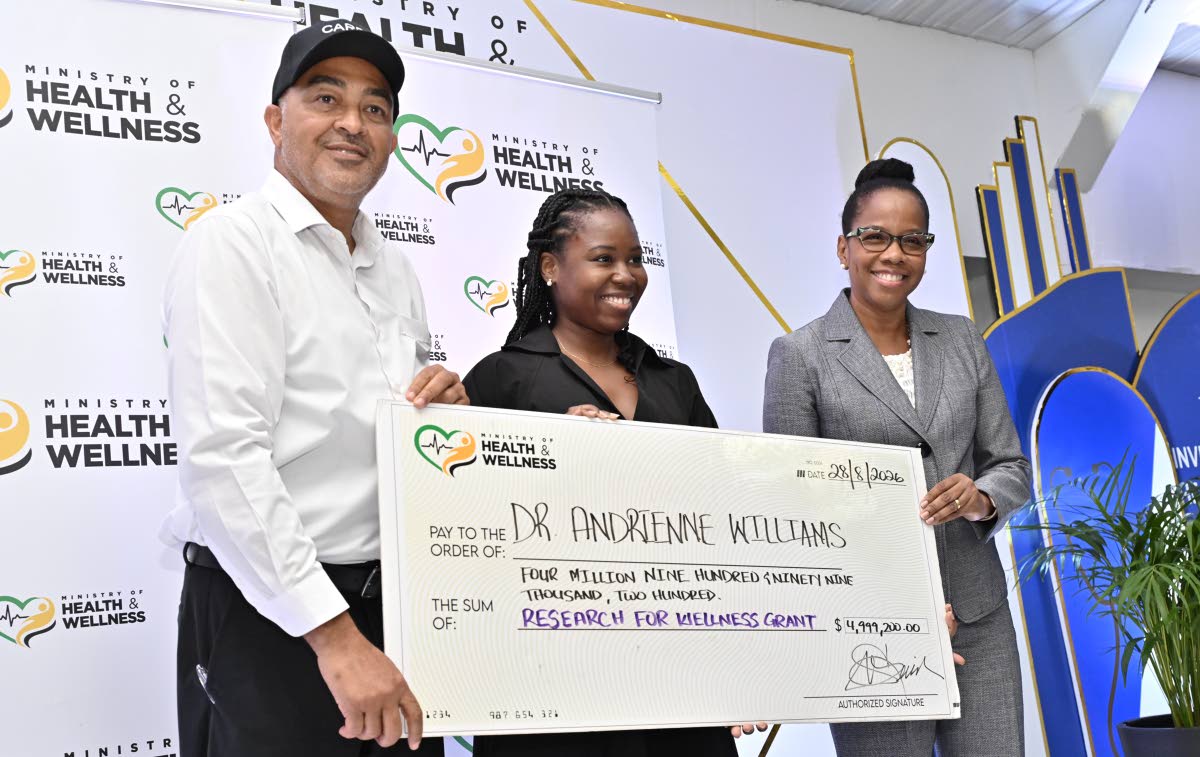 Dr Christopher Tufton, minister of health and wellness; and Dr Karen Webster Kerr (right), national epidemiologist in the Ministry of Health and Wellness, present a grant to Dr Andrienne Williams for wellness research at the Ministry of Health and Wellness