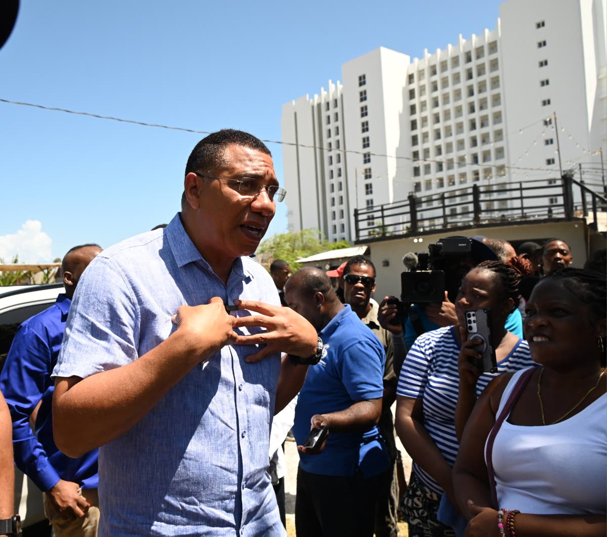 Prime Minister Dr Andrew Holness addresses residents during a tour in Coopers Pen, Trelawny yesterday.