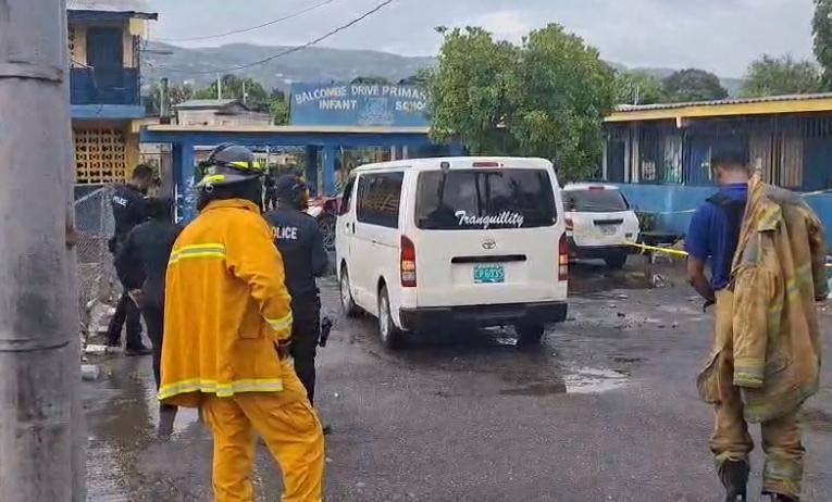 Police and firefighters at Balcombe Drive Primary and Junior High School in Olympic Gardens, St Andrew, where the section of a building collapsed, killing a man and injuring another on September 1.