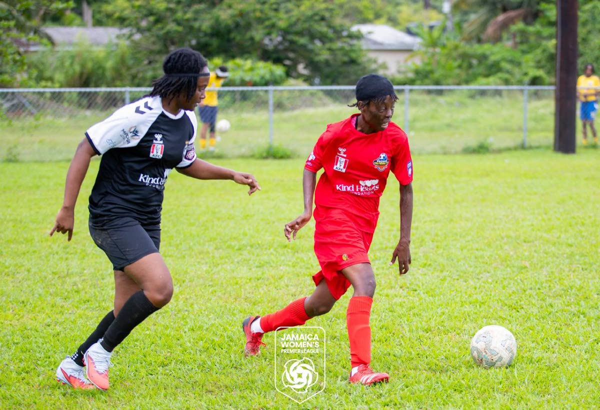 Amoy McKenzie (right) dribbles away from an opponent during a Jamaica Women’s Premier League football match.