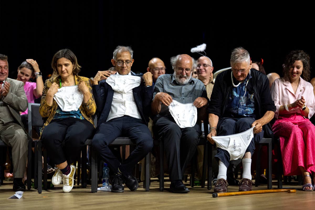 From left: Nobel Prize winners Esther Duflo, Abhijit Banerjee, Michel Mayor and Tim Hunt look at underwear handed over by the Soil Science Award Winners during the Ig Nobel Prize ceremony held in the Zurich Convention Center in Zurich, Switzerland, last Th