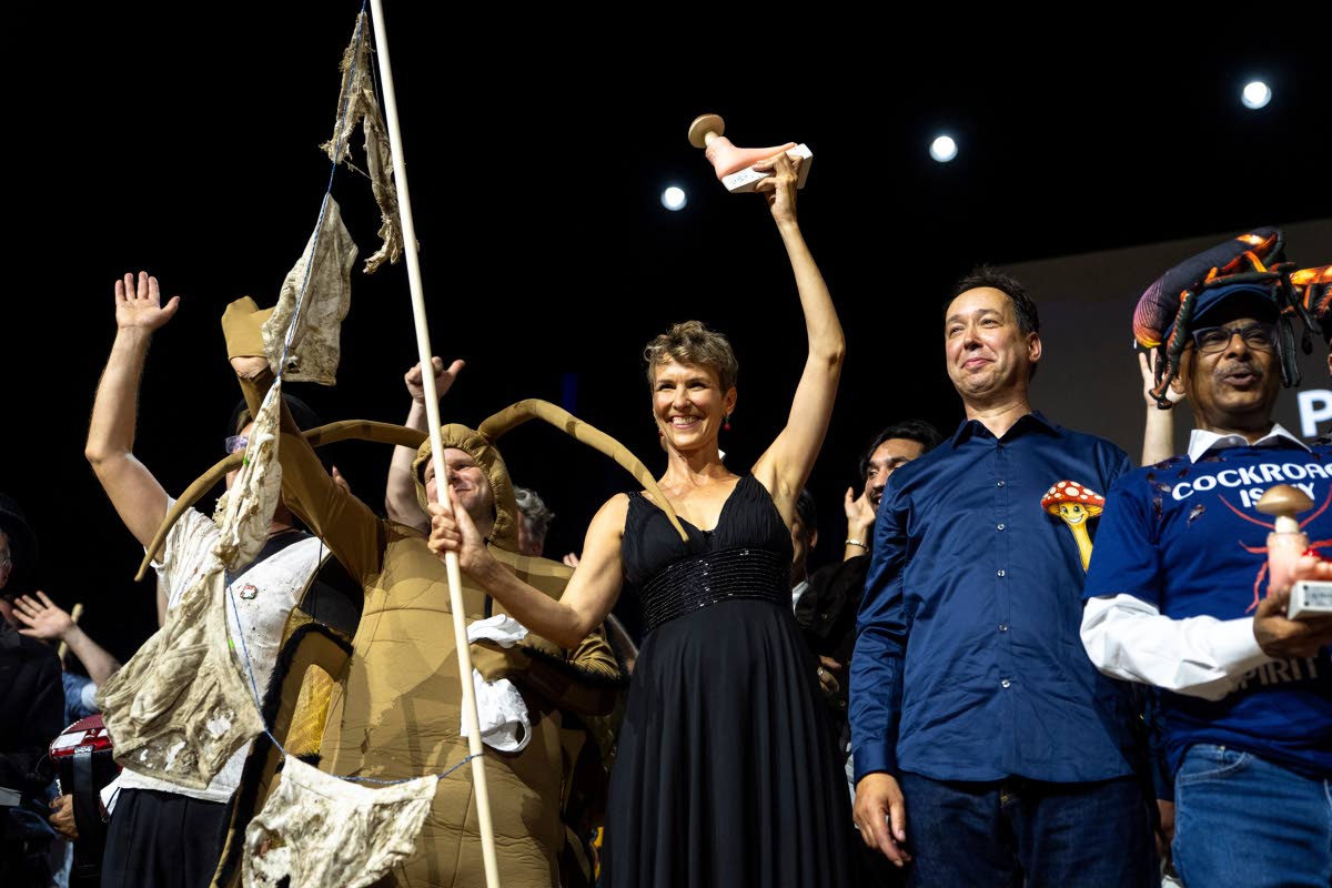 From left: Atlant Bieri, Pia Viviani and Marcel van der Heijden pose with the trophy during the Ig Nobel Prize ceremony held in the Zurich Convention Center in Zurich, Switzerland, last Thursday.