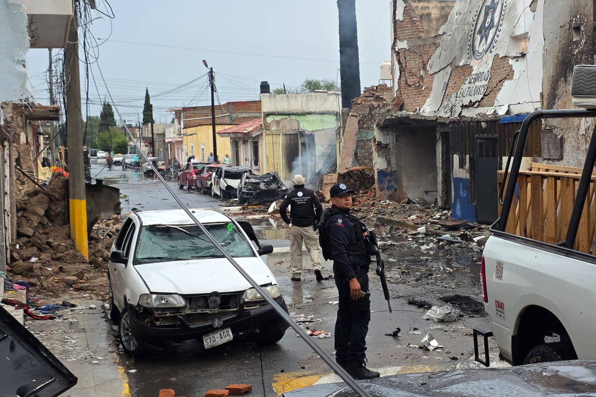 Police stand outside a municipal police station damaged after a car bomb exploded overnight in Ojocaliente, Zacatecas state, Mexico, last Monday.
