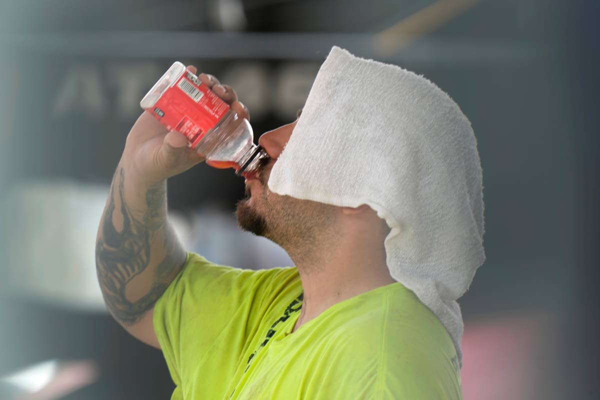 A construction worker hydrates at the Shedd Aquarium, on a hot day in Chicago.