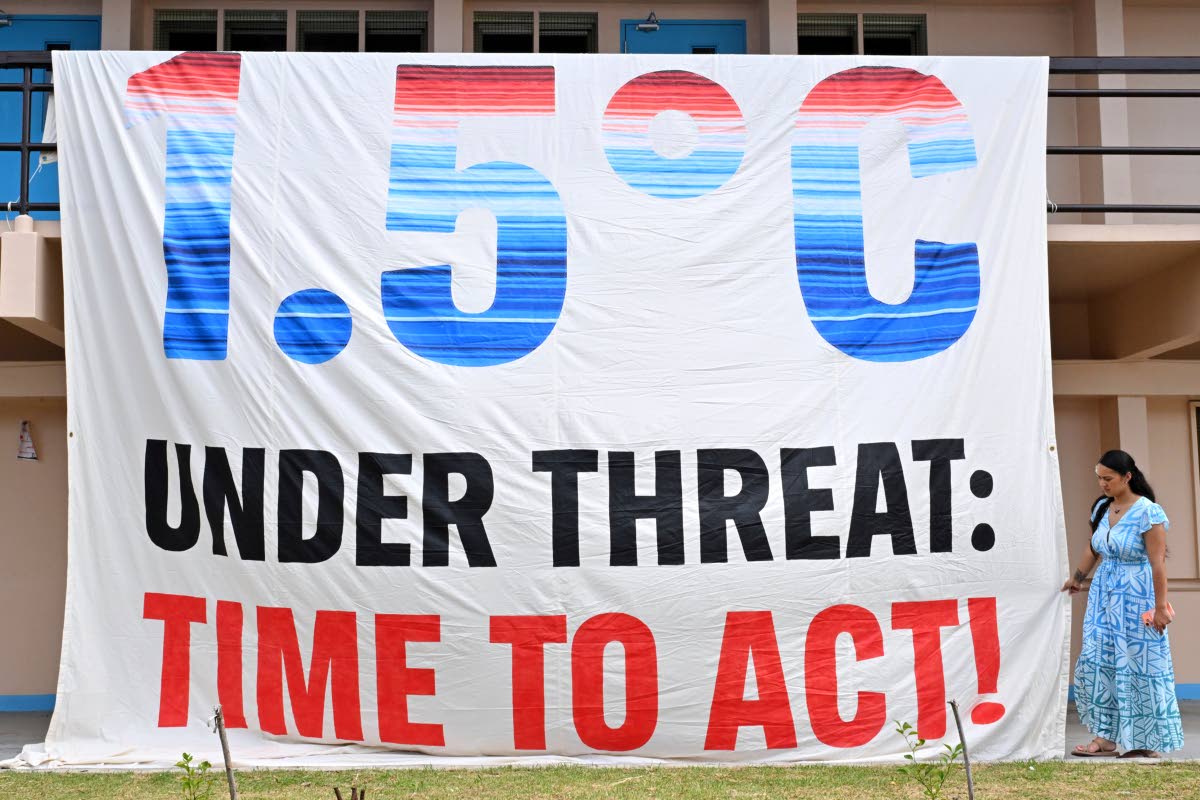 A climate change banner is unfurled by Greenpeace during the Pacific Islands Forum Leaders Meeting in Koror, Palau.