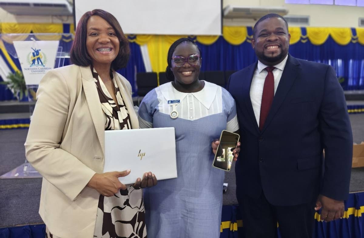 Anastacia Williams shows her phone that she used to do her assignments along with her new laptop presented to her Dr Audrey Gregory, senior vice president of by AdventHealth, and Donmayne Gyles, president and CEO of Andrews Memorial Hospital.