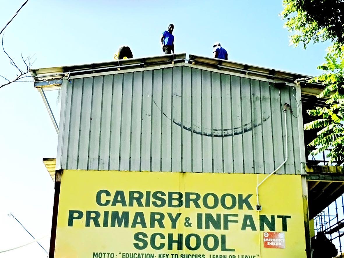 Workmen carry out roof repairs at Carisbrook Primary and Infant School ahead of the school's full return to normal operations.
