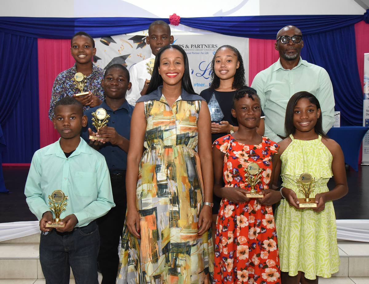 The JPS & Partners Co-operative Credit Union’s 2026 scholarship recipients share a proud moment with keynote speaker Rhoda Moy Crawford (front row, second left), member of parliament, and minister of state in the Ministry of Education, Youth, Skills and 