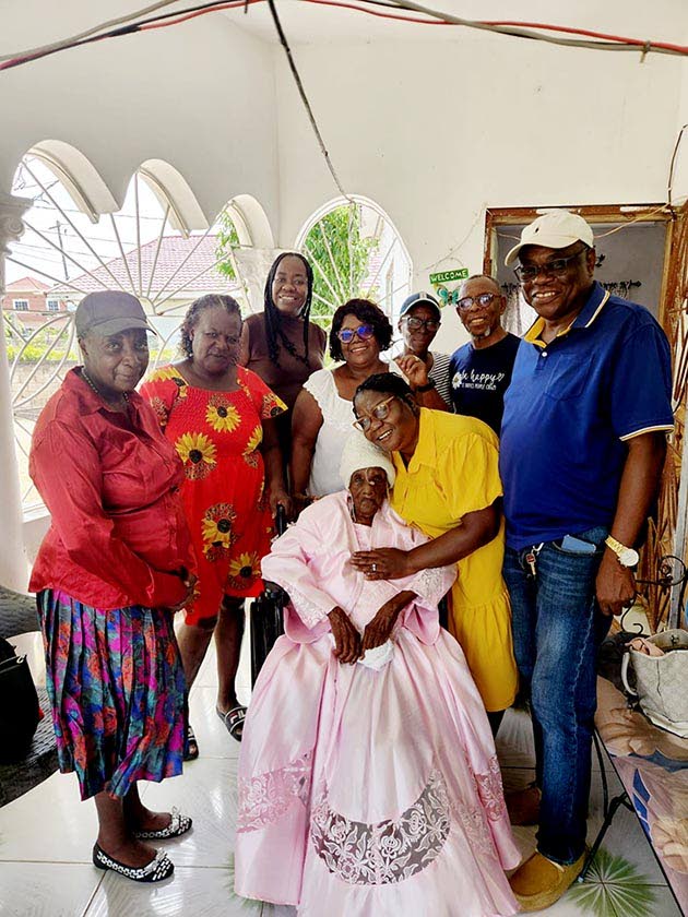 Centenarian Olga Guillermina Small-Williams (centre) is joined by family members and representatives of the St Ann Municipal Corporation during a recognition visit at her home in Salem, Runaway Bay.