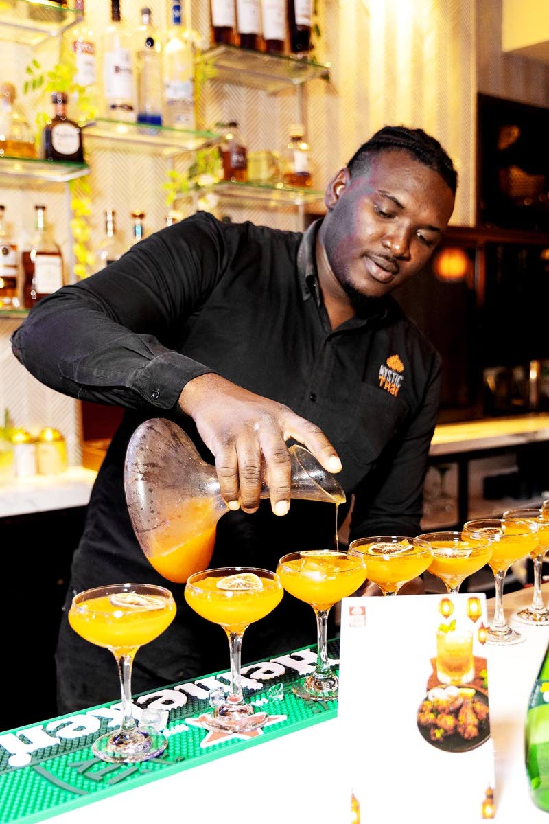 Mystic Thai’s resident mixologist, Conroy Plummer, mixes things up with the paradise reserve cocktails, made with passion fruit.
