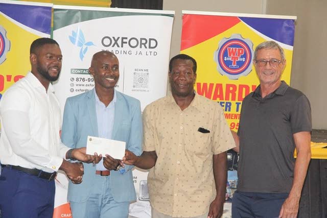 From left: Richard Vernon, mayor of Montego Bay, presents a cheque to Wayne White, a final-year law student, covering $100,000 in scholarship assistance from the Mayor’s Charity Fund. Sharing the occasion are Gregory Harris, councillor for the Salt Sprin