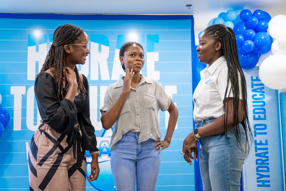 Jusanna Staple (right), brand coordinator, WATA Portfolio, Wisynco Group Ltd, speaks with Jodean Henry of William Knibb Memorial High School and her teacher, Sanese McLeod, during the WATA Hydrate to Educate Awards Luncheon at the S Hotel in Montego Bay on