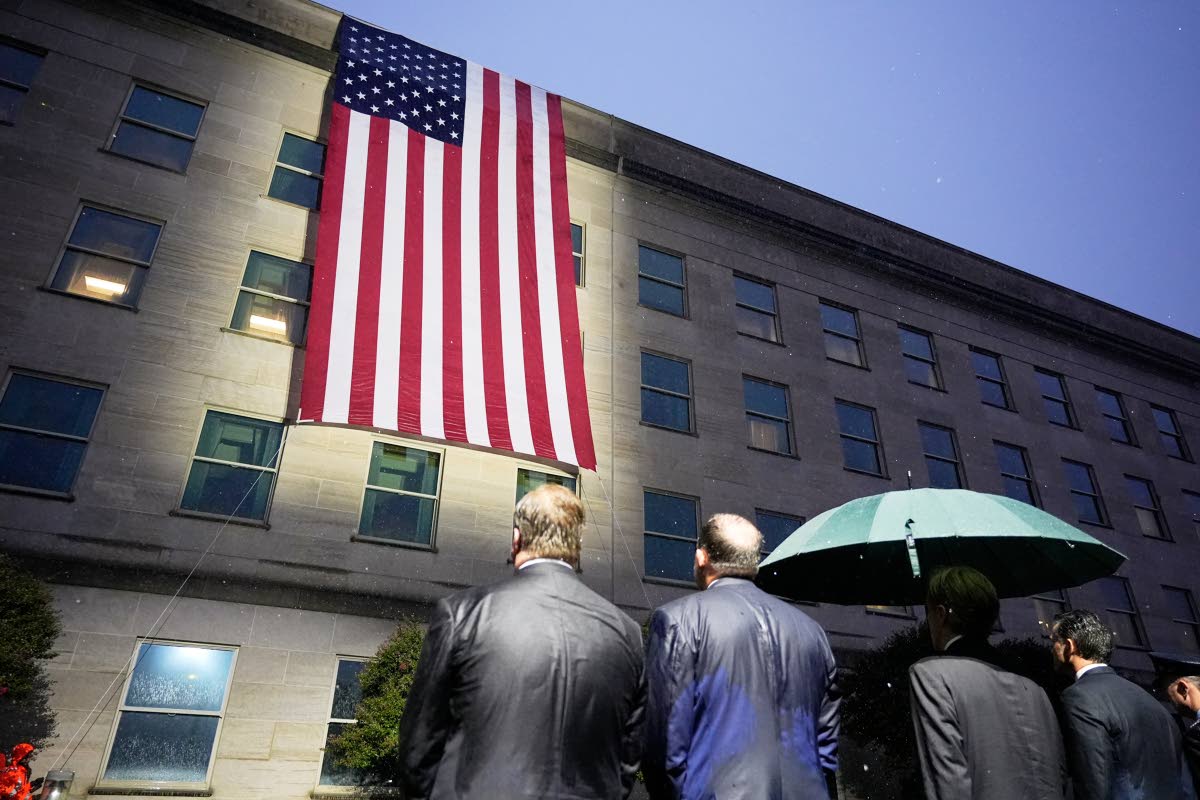 AP 
Secretary of Defense Pete Hegseth, chairman of the Joint Chiefs, Air Force General Dan Caine, and other officials, watch as the flag is unfurled at the Pentagon on September 11, 2026 in Arlington, Virginia.