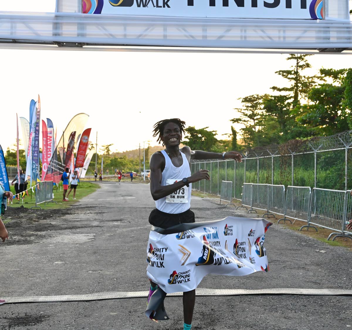 Jamaica College’s Evans Tetteh celebrates his victory as he crosses the 5K MBJ Charity Run/Walk at the Sangster International Airport in Montego Bay on Sunday, September 6.