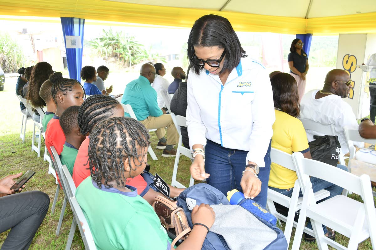 Marilyn McDonald chats with a young student from Darliston Primary School in Westmoreland.