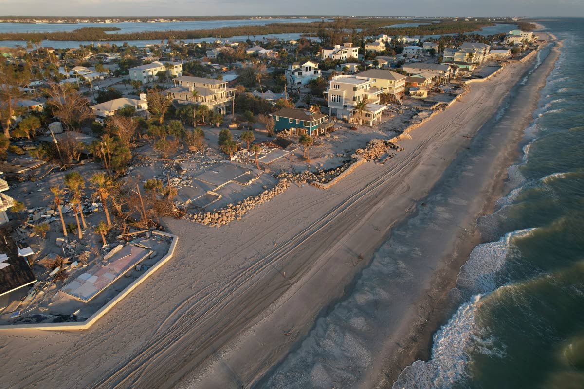 Waves roll in from the Gulf of Mexico toward lots where only empty foundations and debris remain after homes were swept away in Hurricane Milton on Manasota Key in Englewood, Florida, on October 13, 2024.