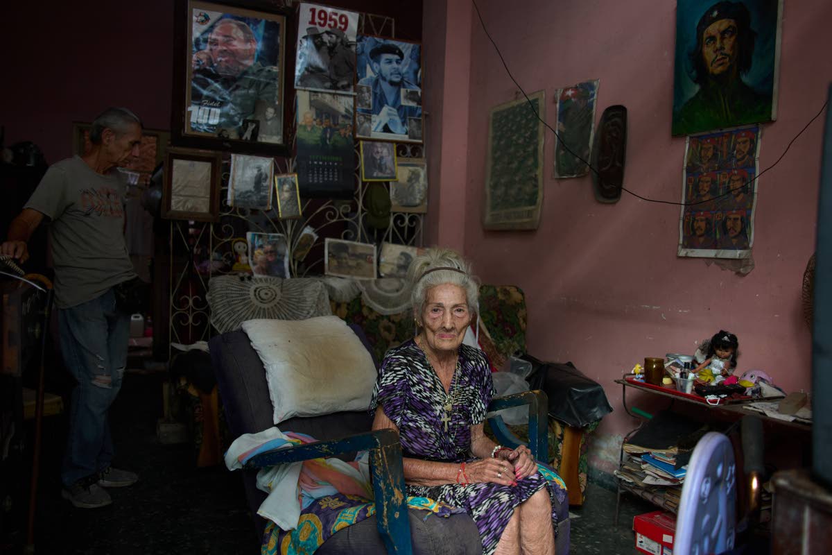 Teresita del Rosario González Ricardo poses for a photo, accompanied by her son José Manuel Borroto, at her home in Havana, Cuba, on September 6.