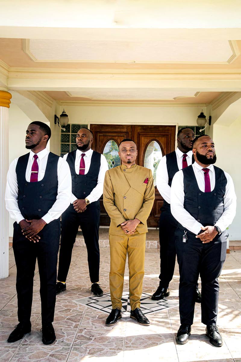 Standing in full support alongside the groom are the dedicated groomsmen. In the back row are Carl Cato (left) and Michkail Barton. Positioned in the front row are Phyl Haughton (left) and best man, Donjay Clarke.