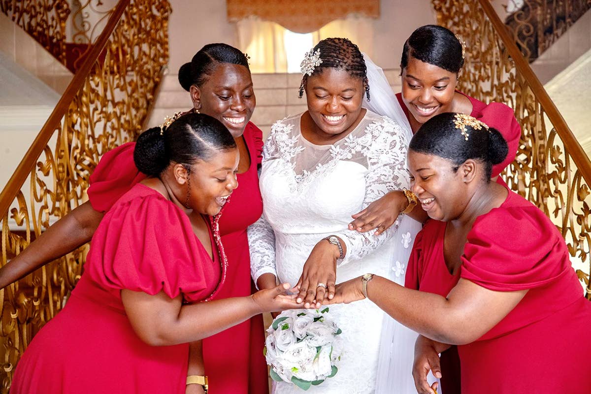 The glowing bride is happy to have (from left) maid of honour Tiwarna Brown and bridesmaids Lotoya Walters, Nashoney Brevett, and Danielle Brown by her side.