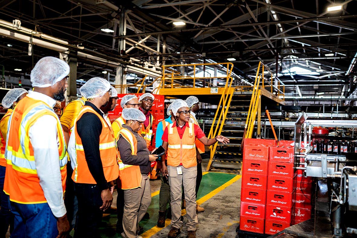 Tameika Grant, packaging manager at Red Stripe, gives a walk-through of the packaging plant.