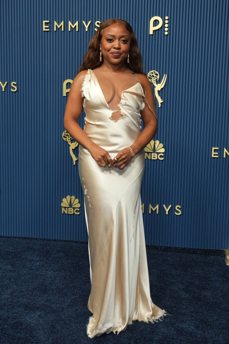 Quinta Brunson glides onto the carpet in a bias-cut silk gown from Christian Cowan’s Spring/Summer 2027 collection.