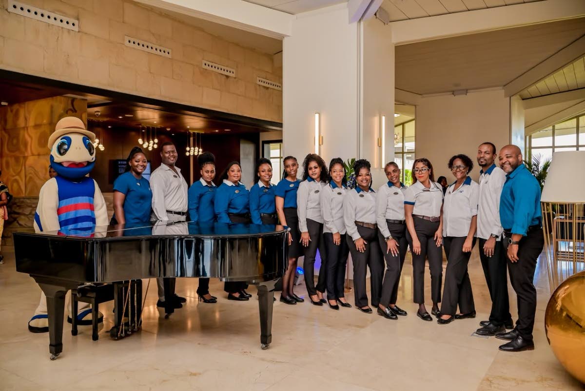Staff at Royalton Blue Waters Trelawny pose for the camera as the resort accepts its first guests after 11 months of closure.