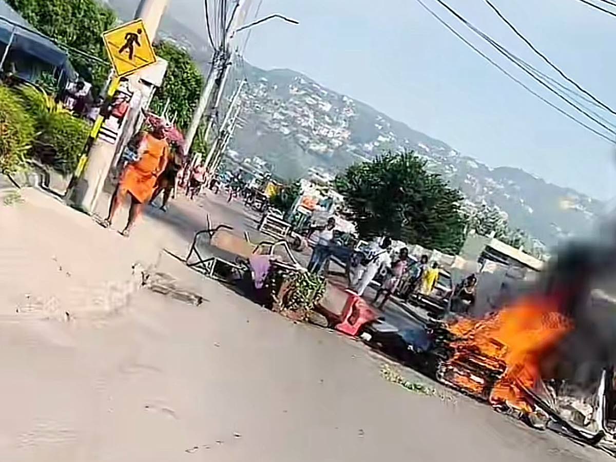 A fiery roadblock mounted along Red Hills Road in St Andrew by residents protesting a fatal police shooting on September 16, 2026.