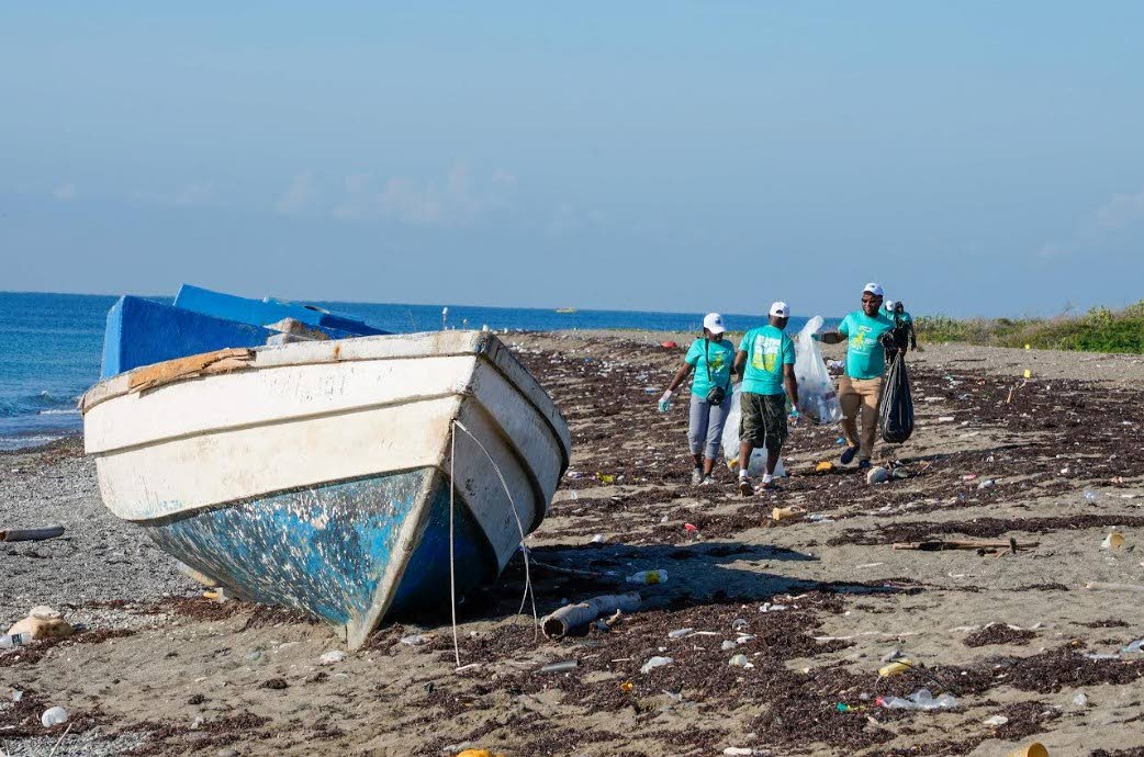 Volunteers work together to remove garbage from the Port Royal Beach as part of a beach clean-up activity hosted by the European Union Delegation to Jamaica, in recognition of an earlier International Coastal Clean-Up Day. 