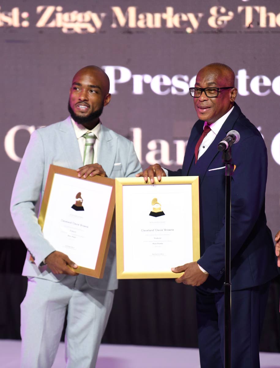 Clevie Browne (right) is all smiles as he collects his awards from Joel Laing.