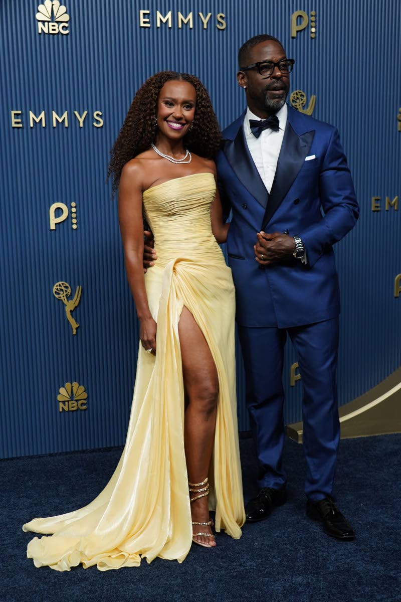 Ryan Michelle Bathe and Sterling K. Brown make a stylish pair. Bathe brings softness in a strapless yellow gown with a high slit, while Brown keeps things sleek in Brunello Cucinelli. 
