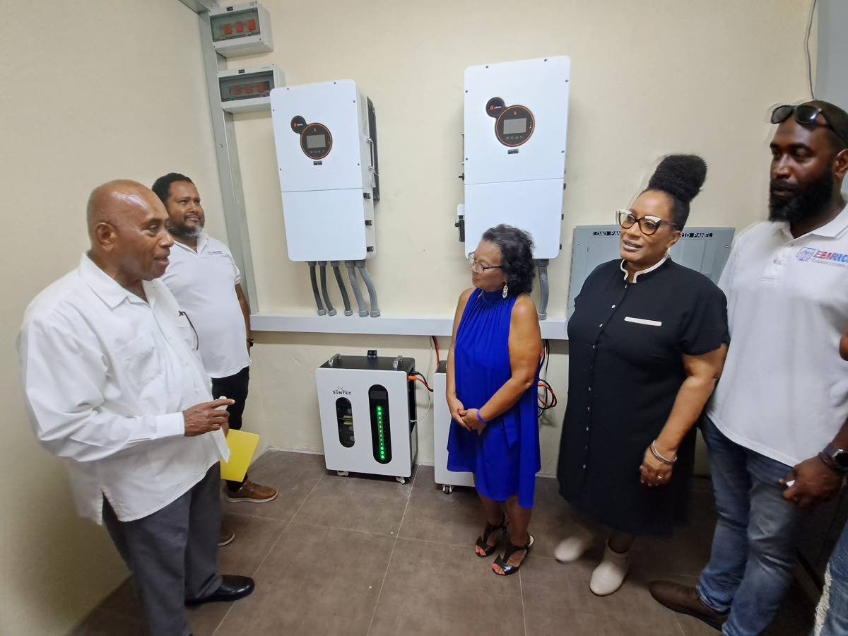 From left: Monsignor Eremodo Muavesi, rector of the Blessed Sacrament Cathedral in Montego Bay, St James, formally blesses Mount Alvernia High School’s new solar-power system on Wednesday. Vaden Maragh, managing director of EMRIC Solutions Limited; Dawn 