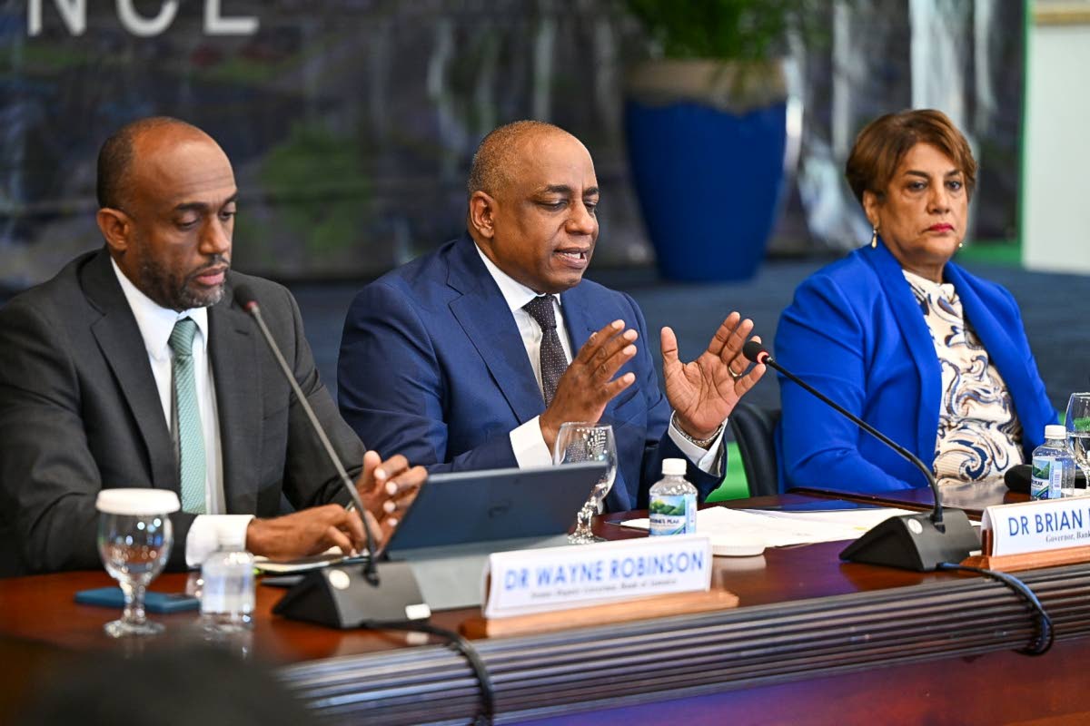 Newly appointed Bank of Jamaica (BOJ) Governor, Dr Brian Langrin (centre) responds to questions during the Quarterly Monetary Policy Press Conference held at the BOJ Auditorium in downtown Kingston on Thursday, August 20. Listening are Senior Deputy Govern