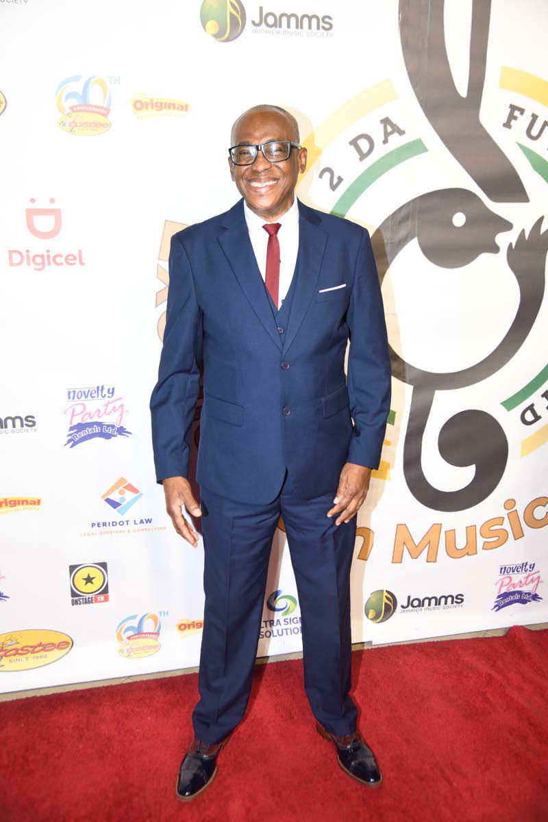 Musician and producer Cleveland ‘Clevie’ Browne keeps things classic in a timeless two-piece navy blue suit. 