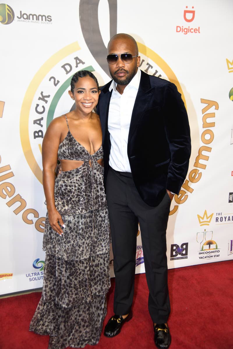 Jeffrey Campbell (right), more popularly known as recording artiste Agent Sasco, keeps it sharp in a velvet blazer and dark trousers, alongside his wife, Nicole McLaren-Campbell, founder and chief executive officer of AIM Educational Services, who wears a 