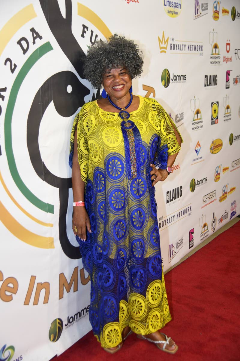 Artiste manager Bridgette Anderson brings vibrant colour to the occasion in a yellow and blue African-print boubou dress.