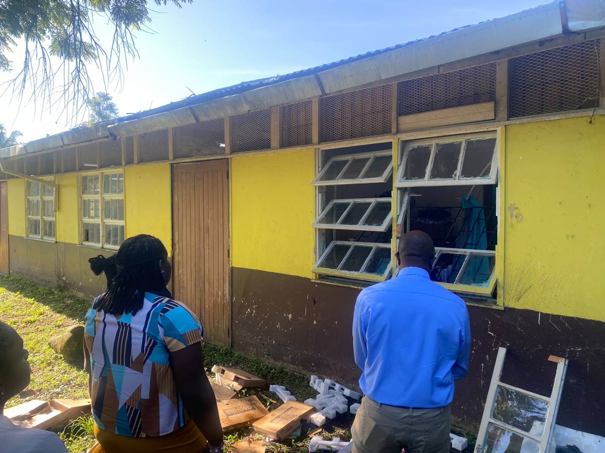 Staff members at Bickersteth Primary and Infant School in St James survey the damage done to a section of the premises, following a break-in at the institution on Wednesday night.