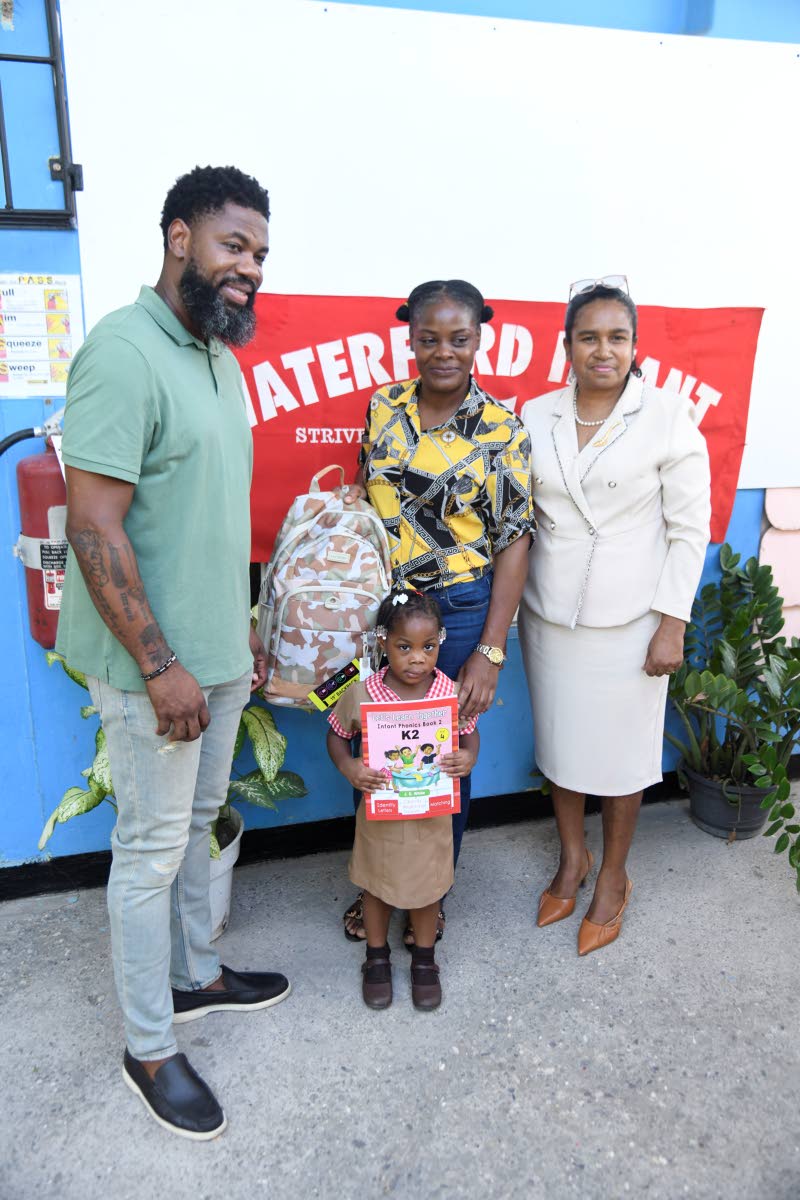 Brissett shares a smile with Denese Dixon and little Mylah Haughton during a back-to-school giveback on Monday, as Waterford Infant School principal Marcia Henry looks on.