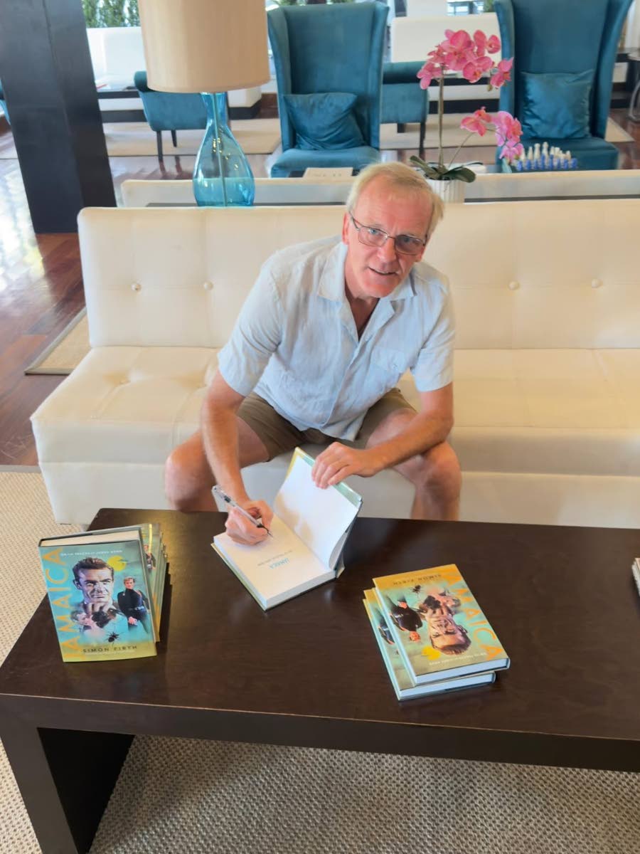 Author Simon Firth signs copies of his book, ‘Bond in Jamaica’.